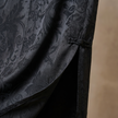 Black Jacquard fabric with intricate floral pattern close-up