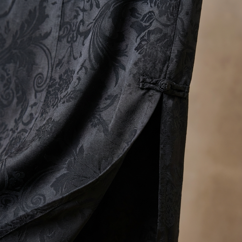 Black Jacquard fabric with intricate floral pattern close-up