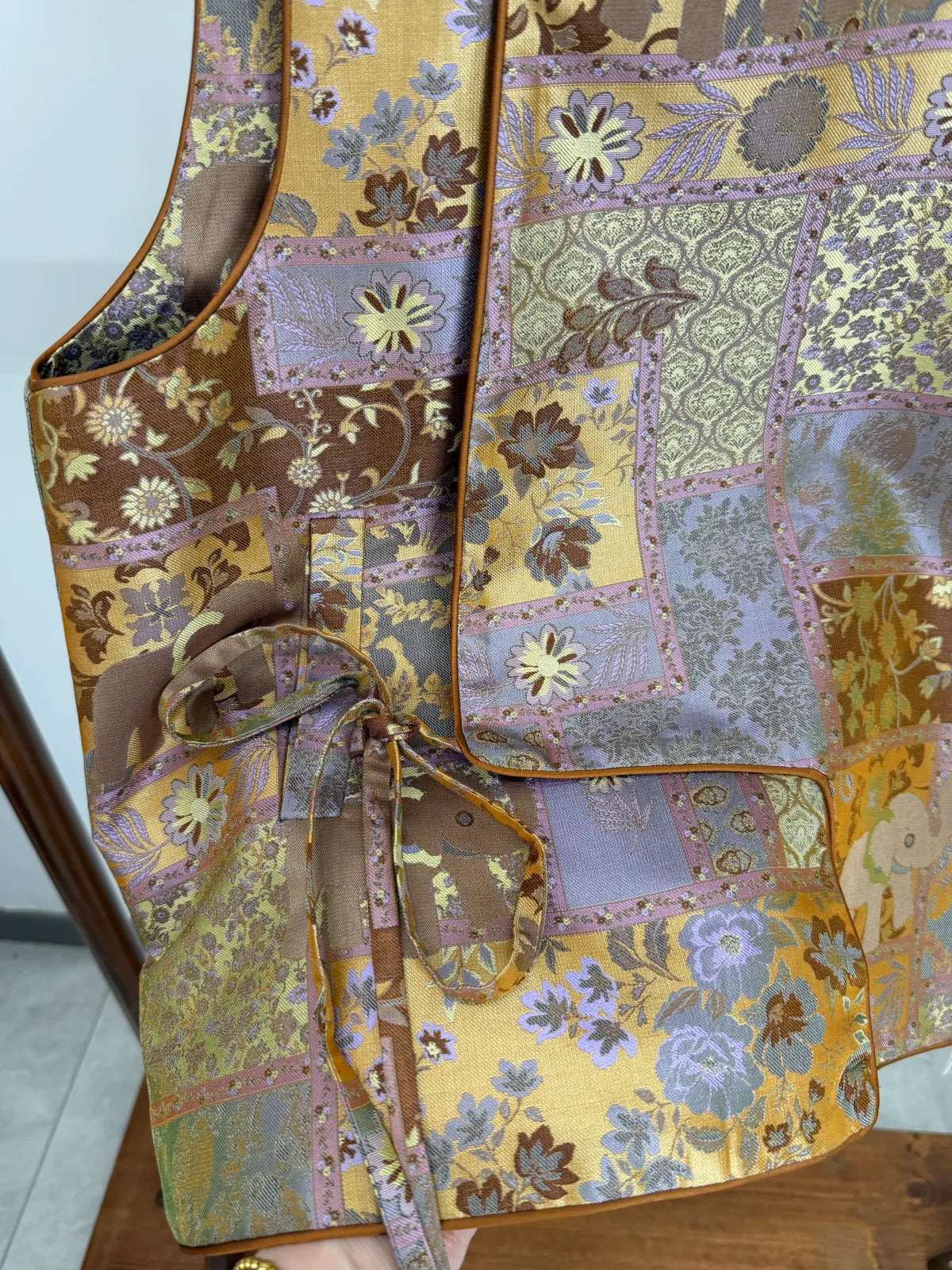 Fabric close up of the brown patchwork vest from luxe orienta 