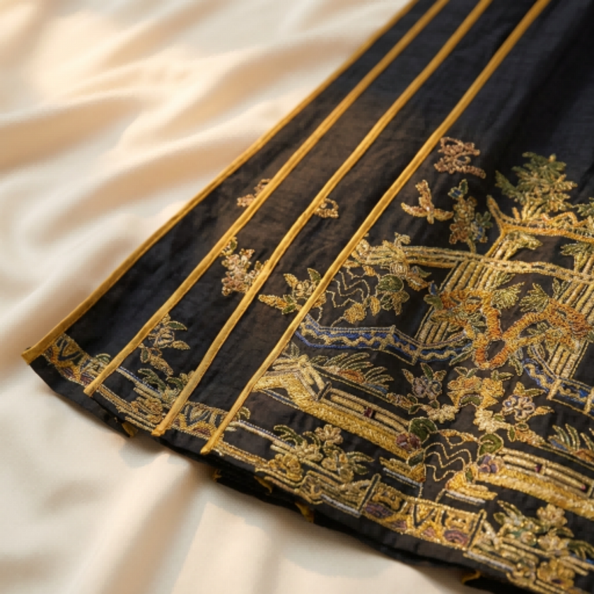 Close-up of black fabric with gold embroidery for the ma mian qun skirt