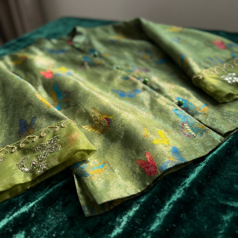 Green Mulberry silk  fabric with butterfly patterns and gold embroidery on a green background