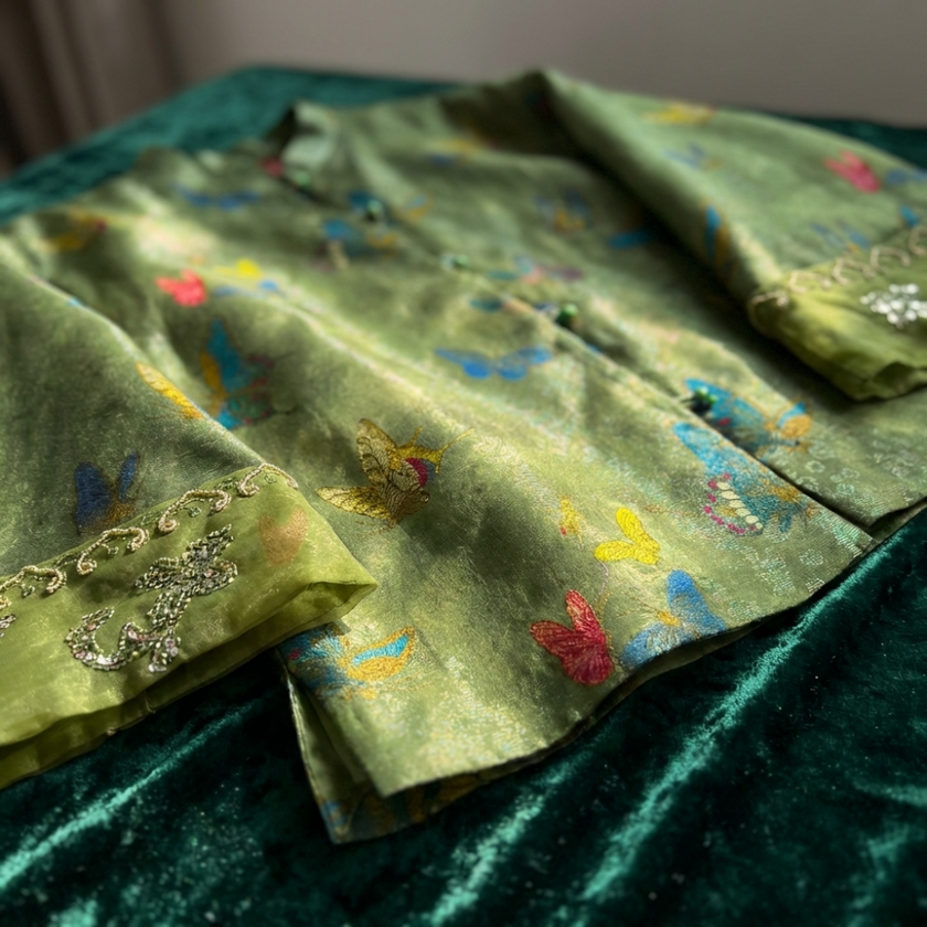 Green Mulberry silk  fabric with butterfly patterns and gold embroidery on a green background