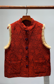 Red textured vest with fur trim on a hanger against a gray background