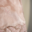 Close-up of a pink jacquard  blouse with intricate detailing.