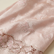 Close-up of pink fabric with butterfly embroidery