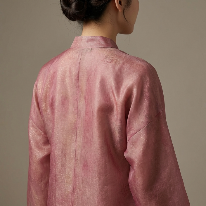 Female Model wearing a pink floating lightbrocade blouse back view