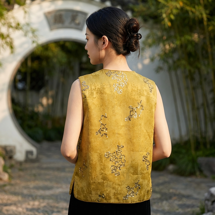 Woman wearing a yellow sequined embroidered vest in an outdoor setting