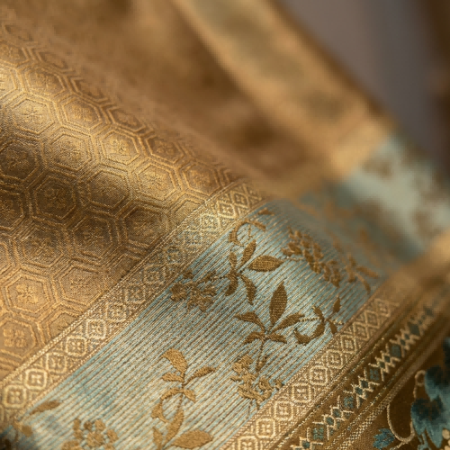 Close-up of textured fabric with geometric and floral patterns.