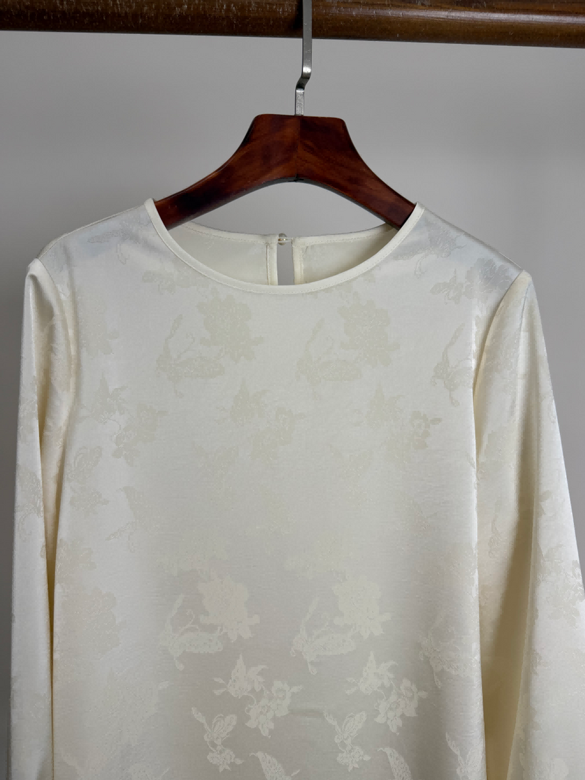 White Tencel Jacquard Lace Patchwork Blouse hanging in the hanger