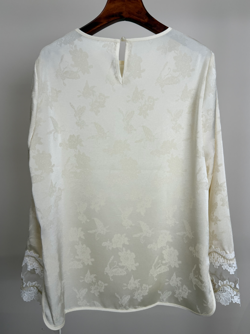 White tencel blouse back view on a hanger 